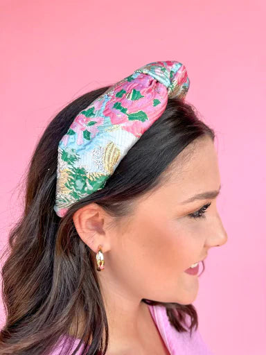 Girl is pictured up close wearing a headband. 