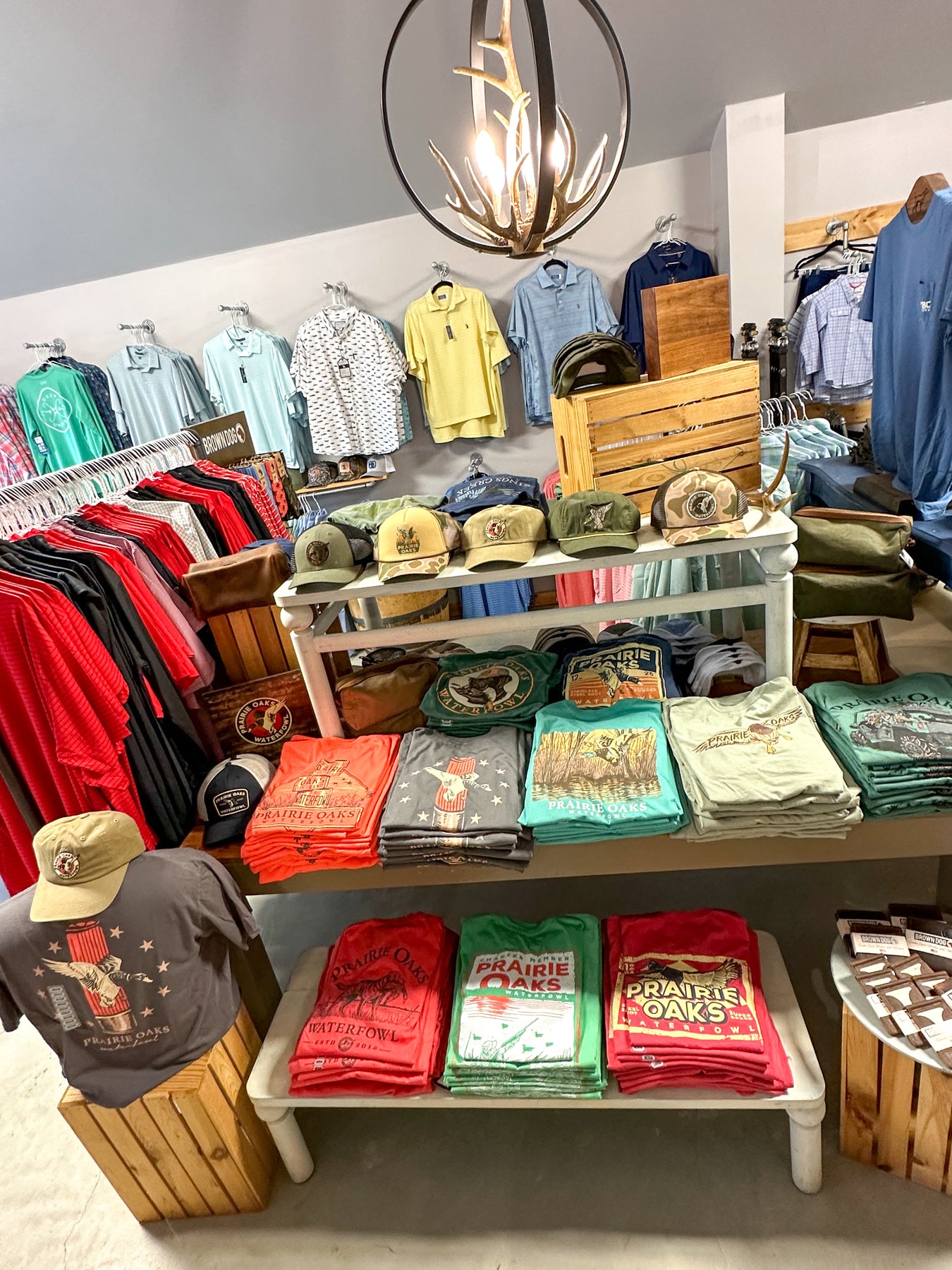 Pictured is a retail display of mens tee shirts and hats.