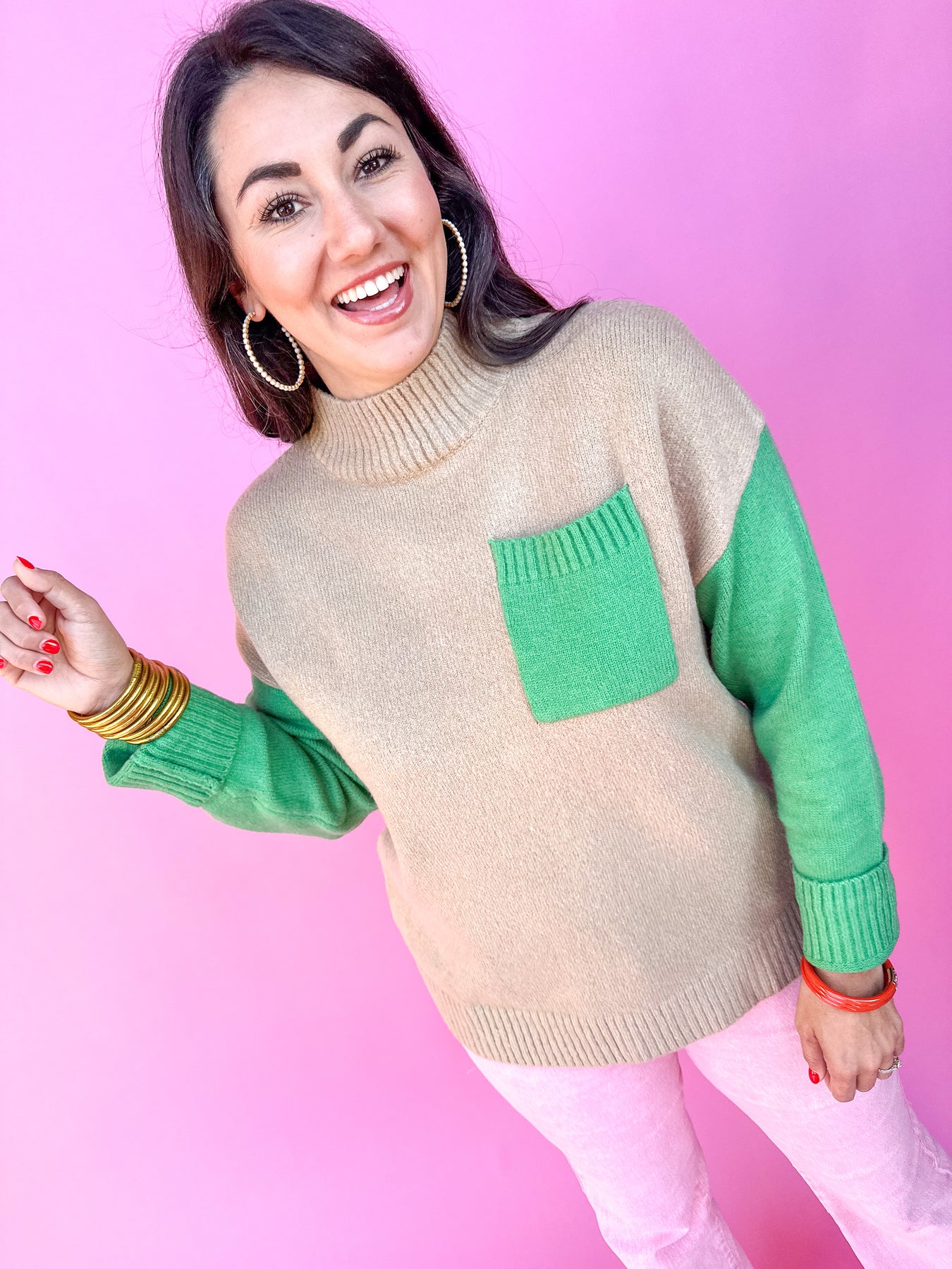 Pictured is a woman in a tan and green sweater.